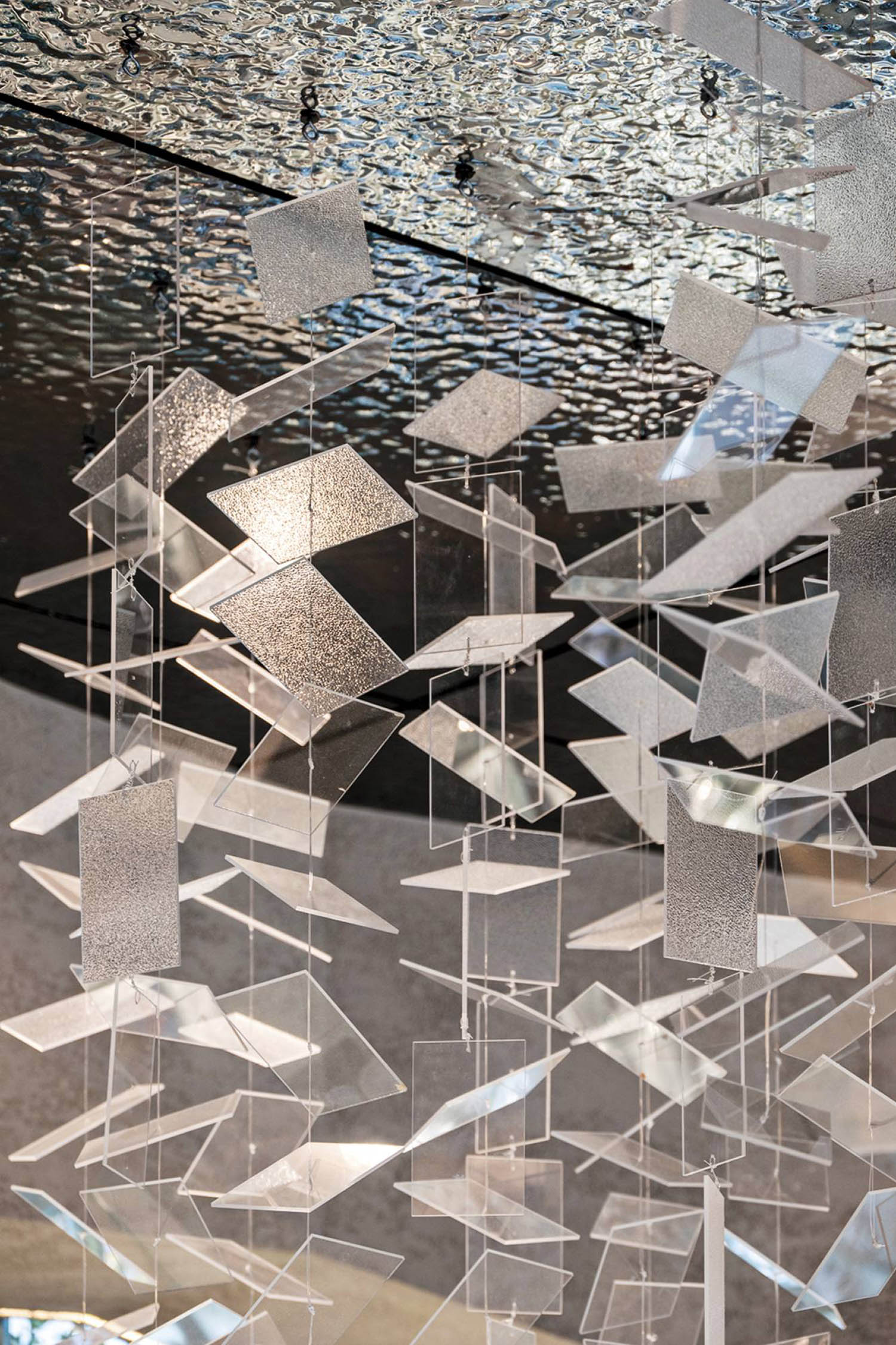 A large group of silver and white glass wind chimes.