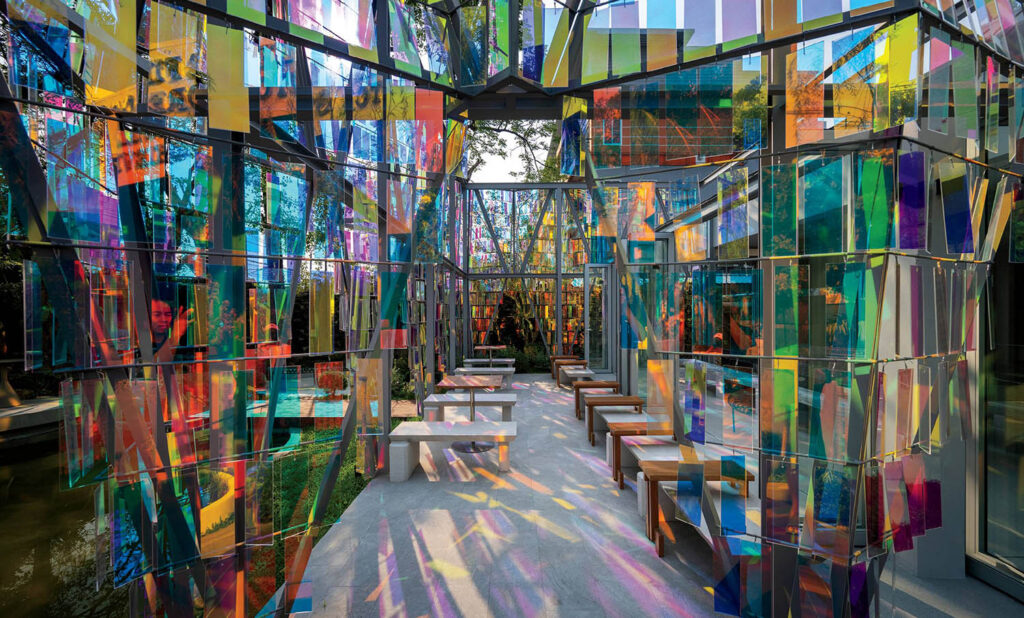 A colorful art installation in a glass walled room.