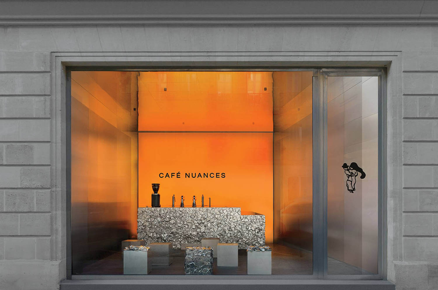 A window display with a vase and a vase.