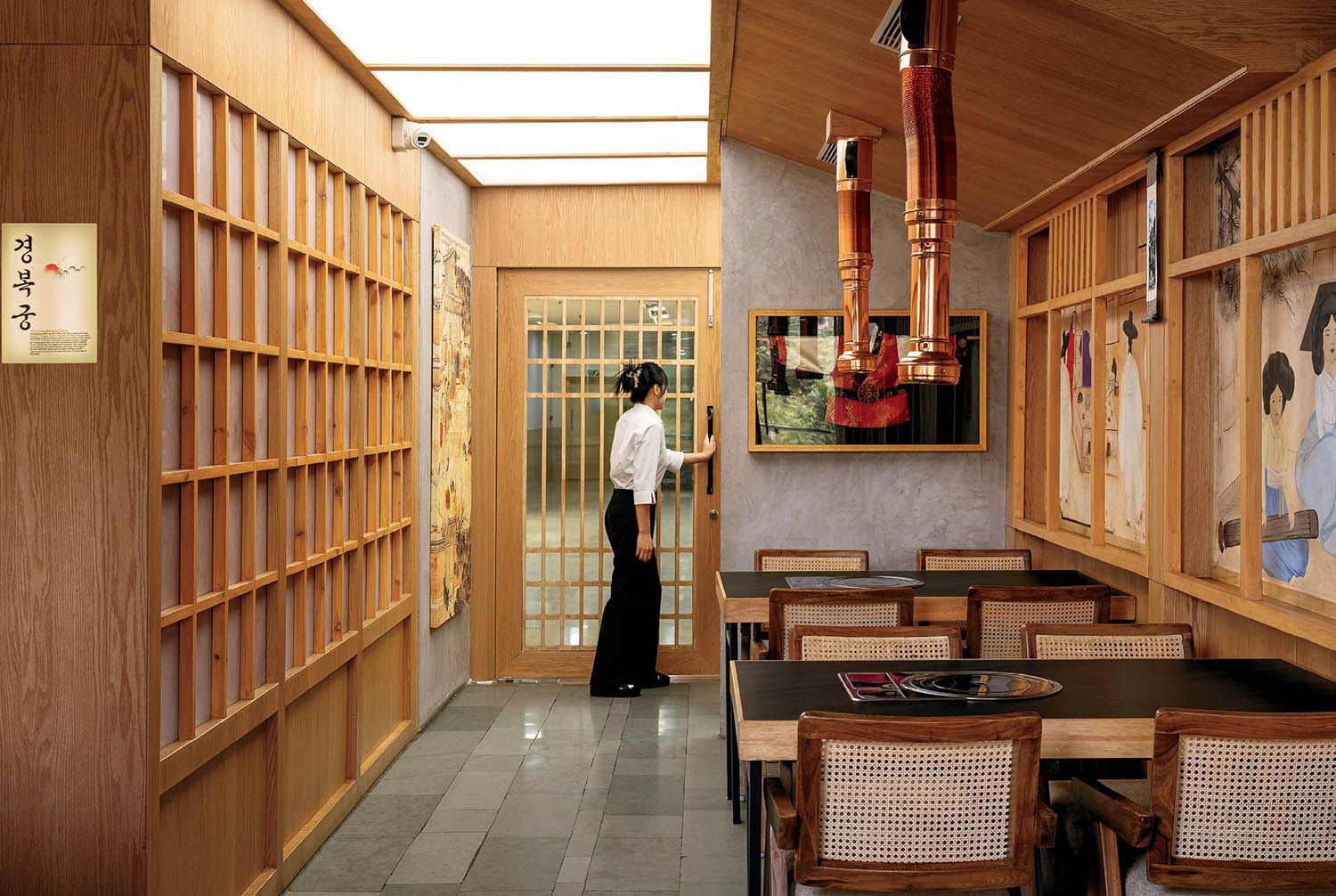 A woman standing in a room with a painting on the wall.