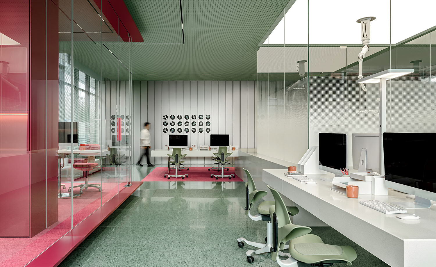 A pink office with a glass wall.
