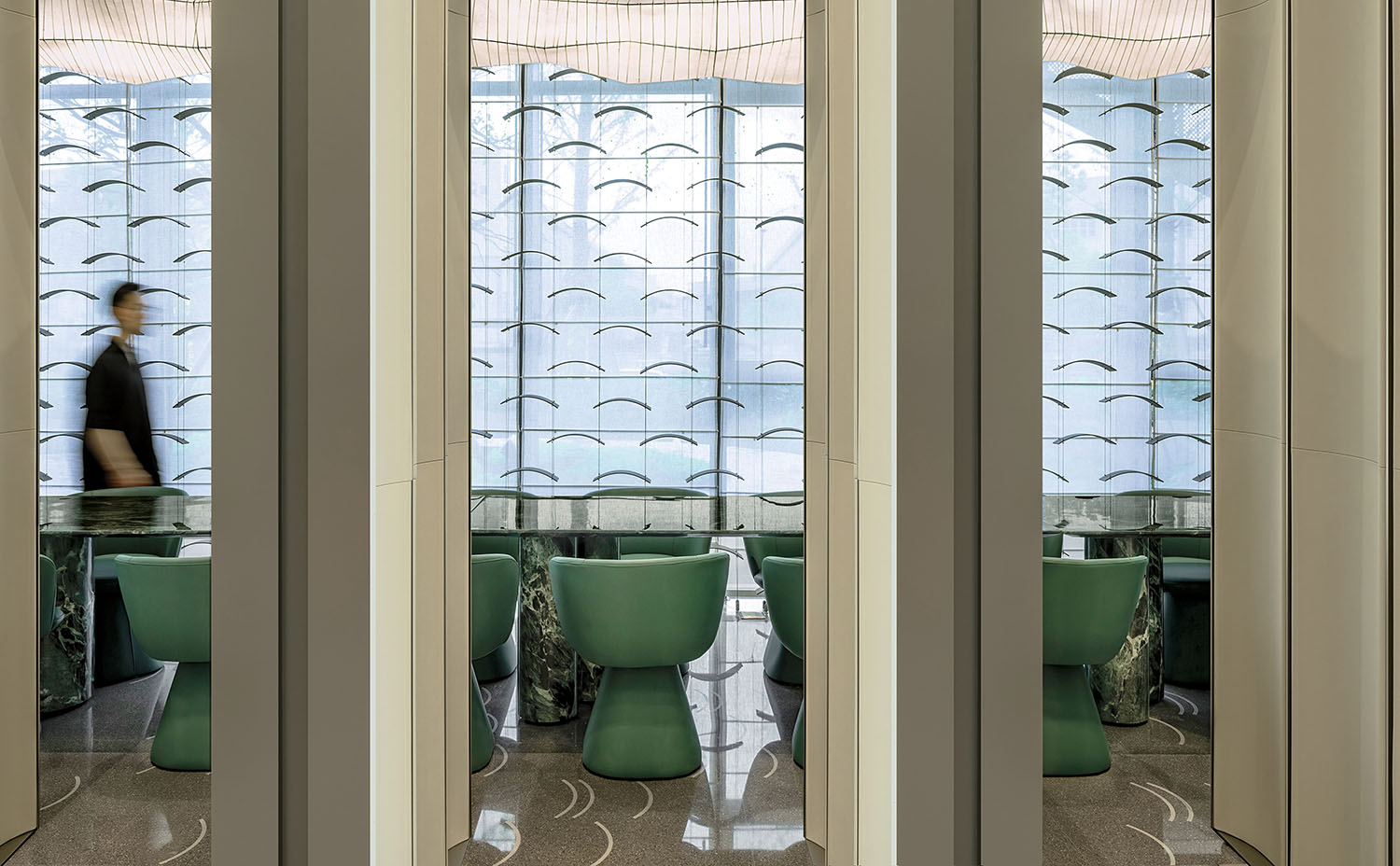 A woman walking through a glass door.