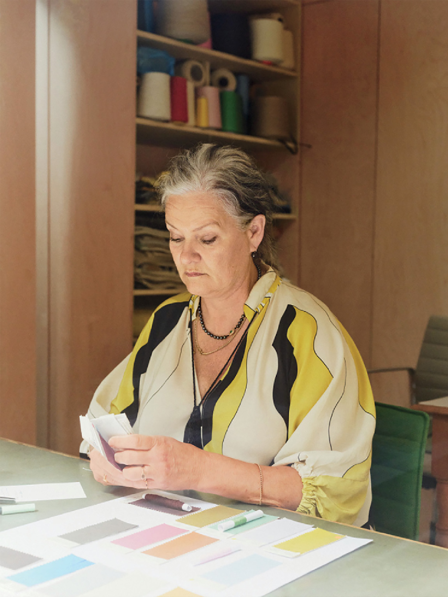 A woman sitting at a table with a cell