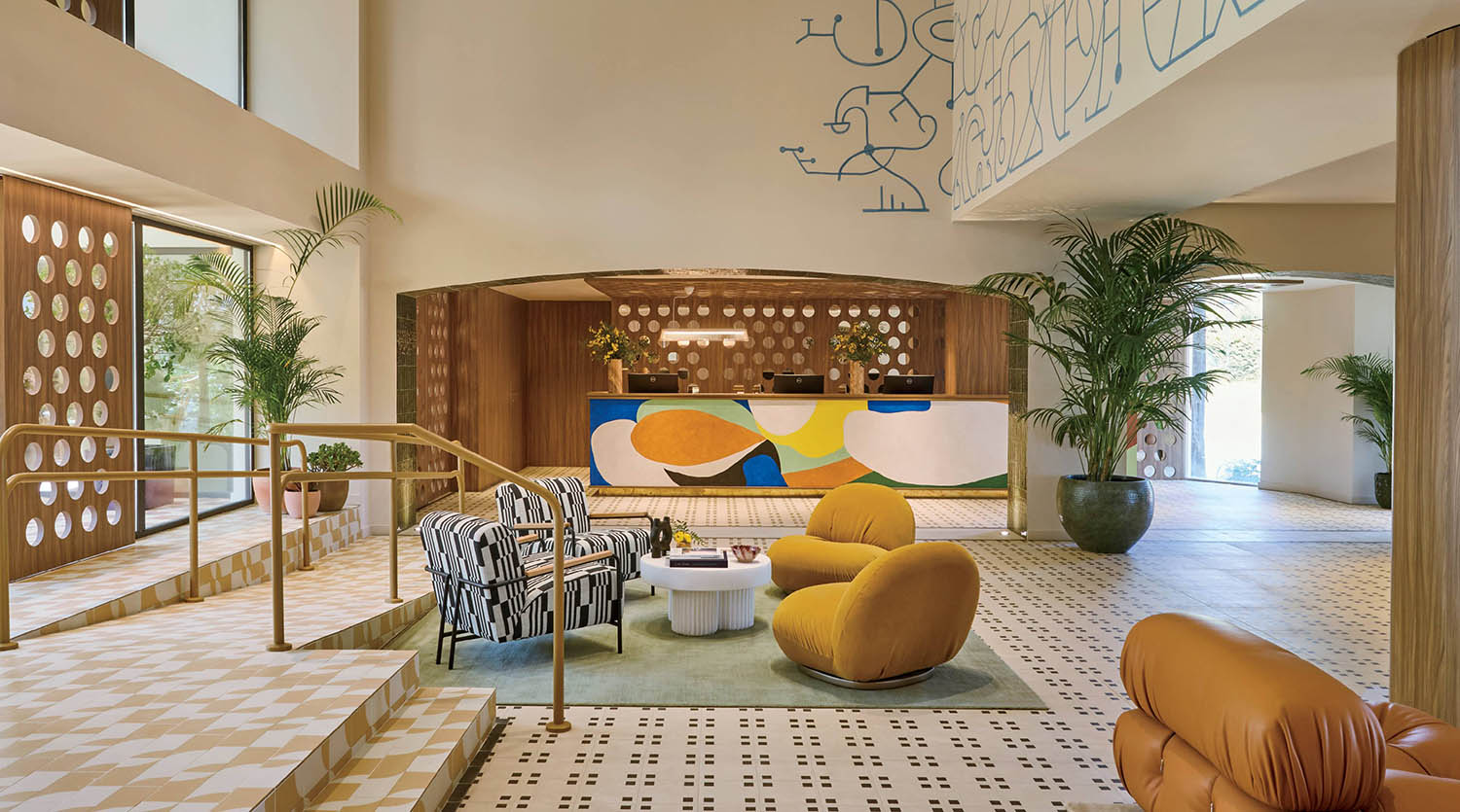 A lobby with a large wall of graffiti on the walls.