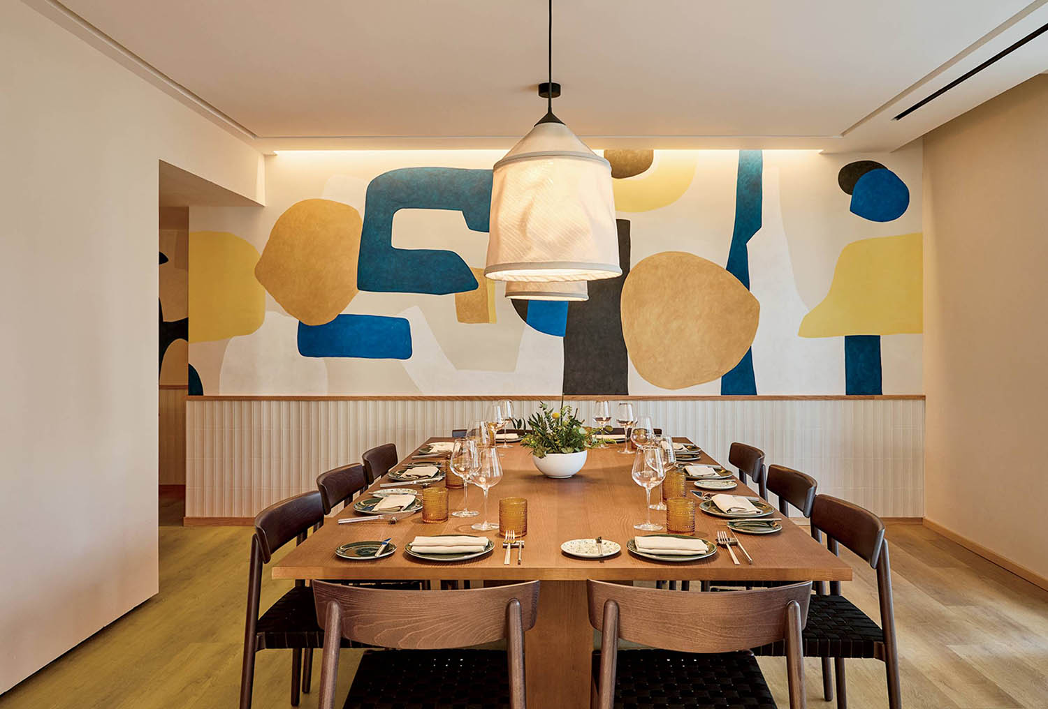 A dining room with a large wooden table.