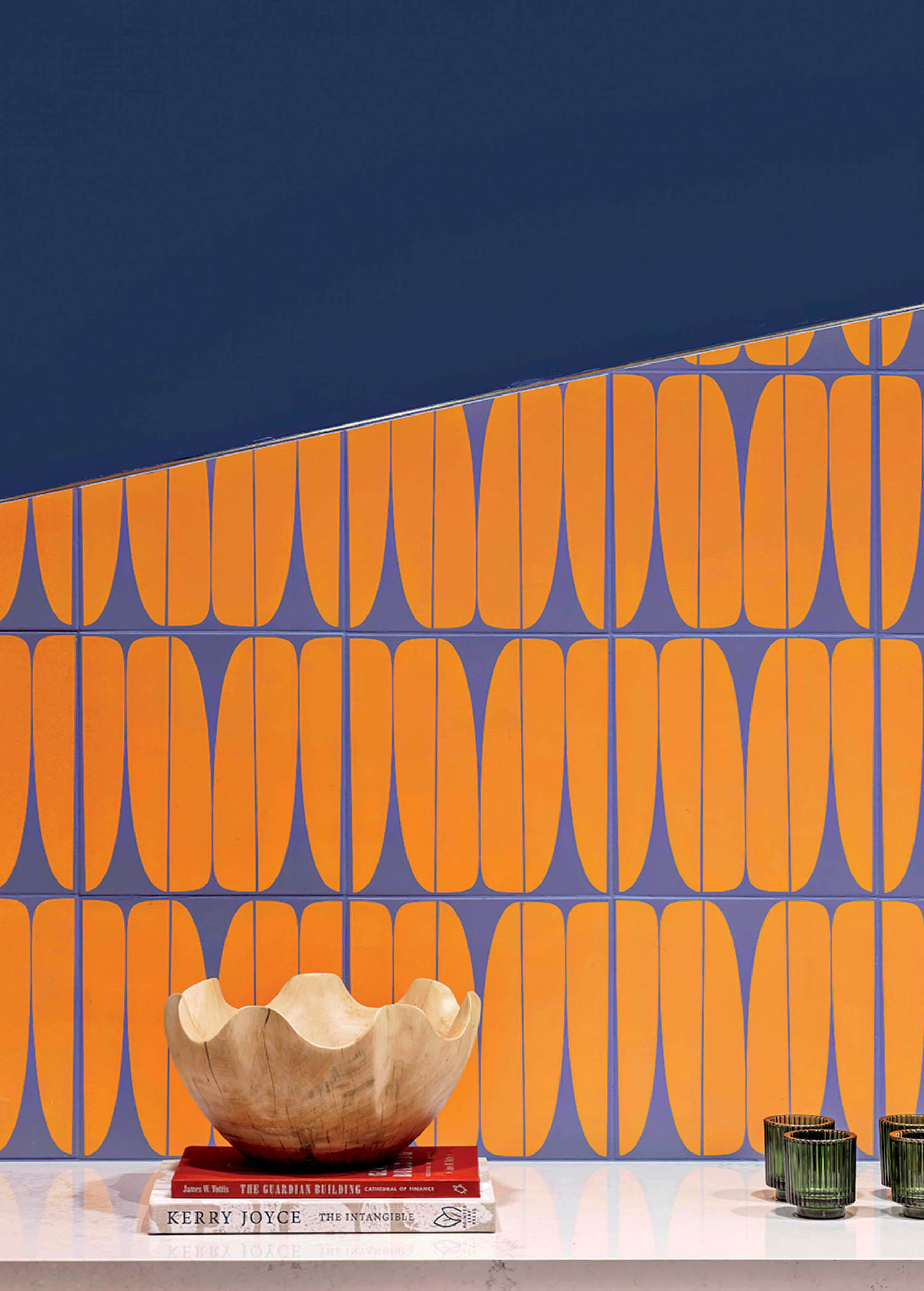 A white table with a vase and a wallpaper.