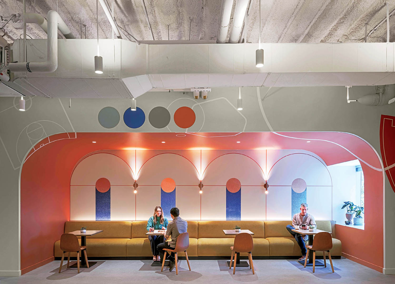 A couple of people sitting at a table in a room.