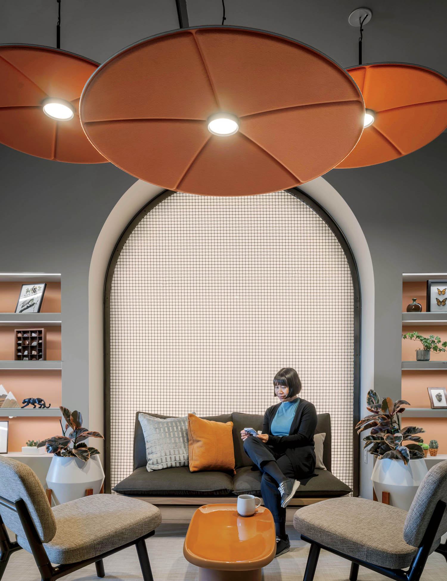 A woman sitting on a couch in a room.