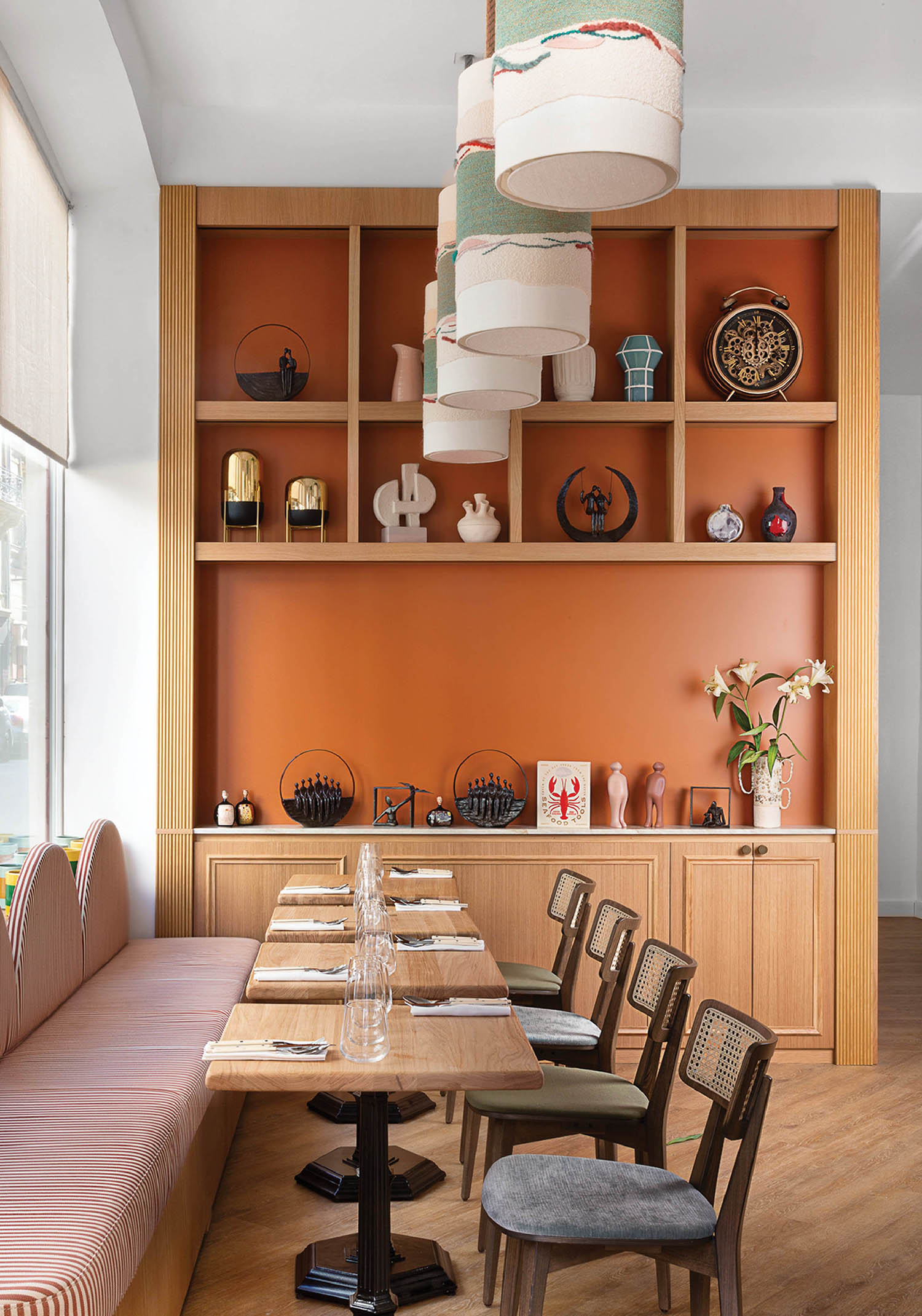 A dining room with a wooden table and a bench.