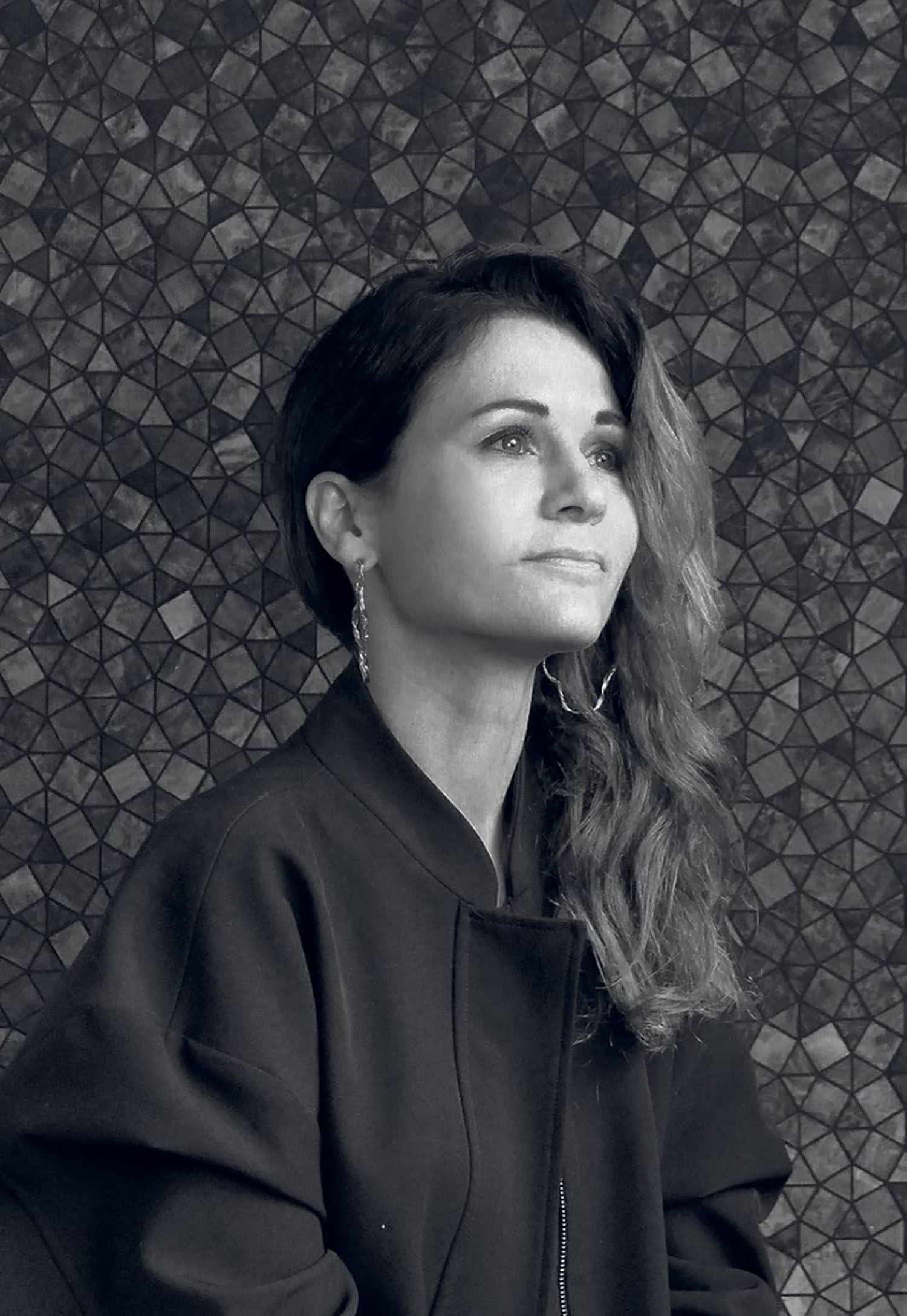 A woman with long hair and a black jacket.