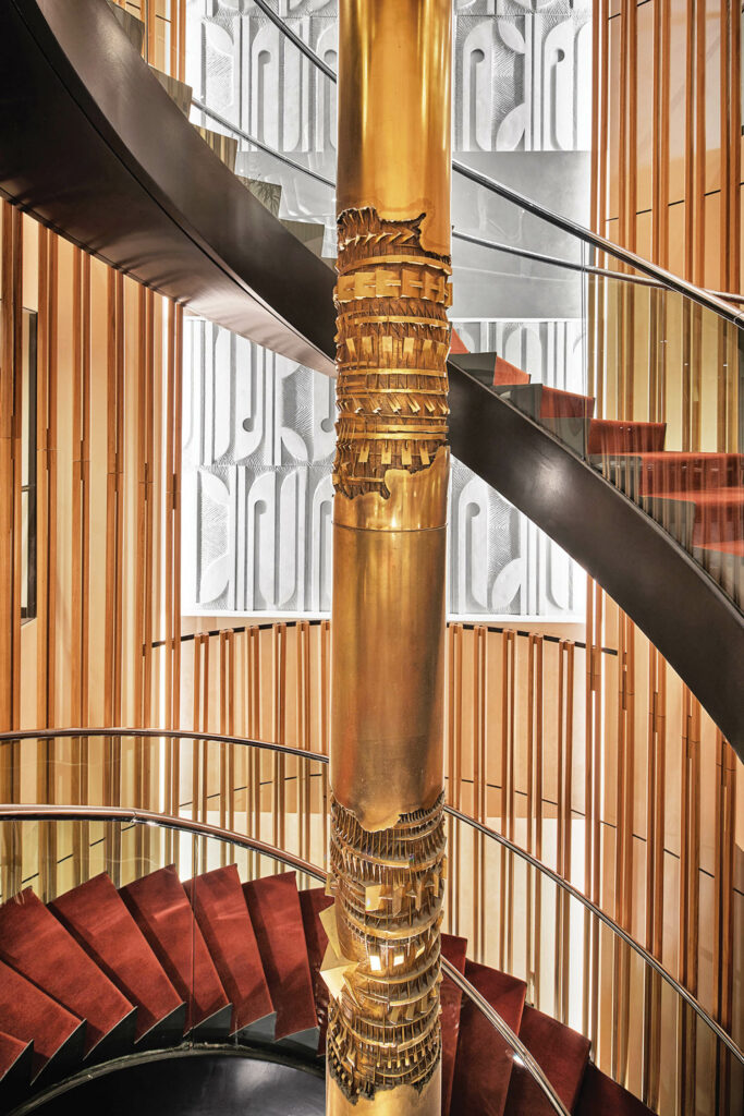 a winding staircase with brass details