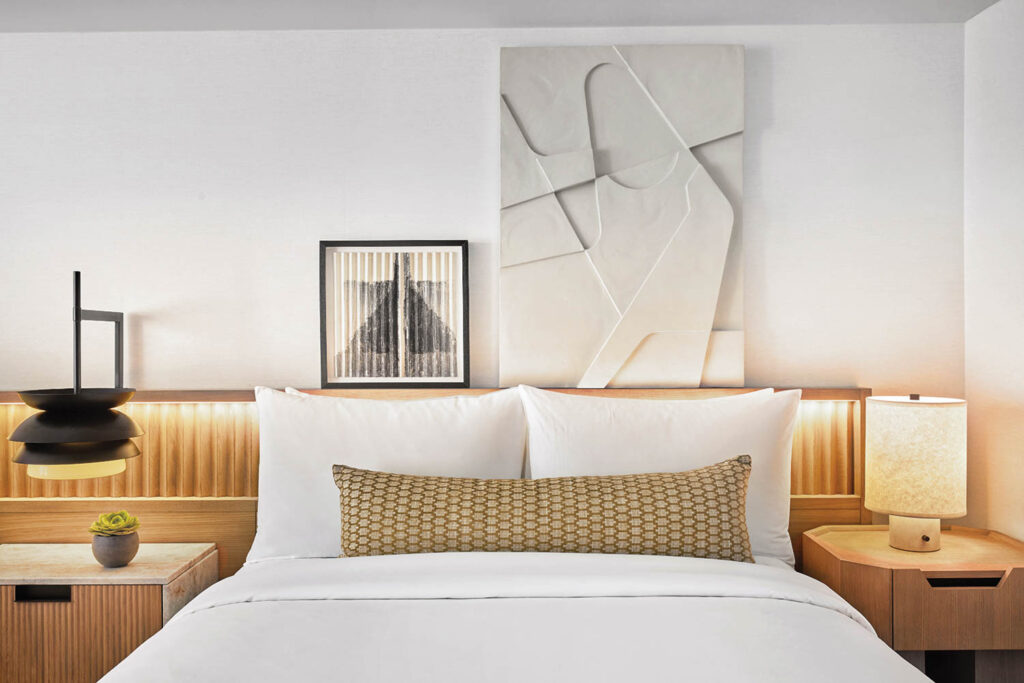 a white guest bed inside the jay hotel