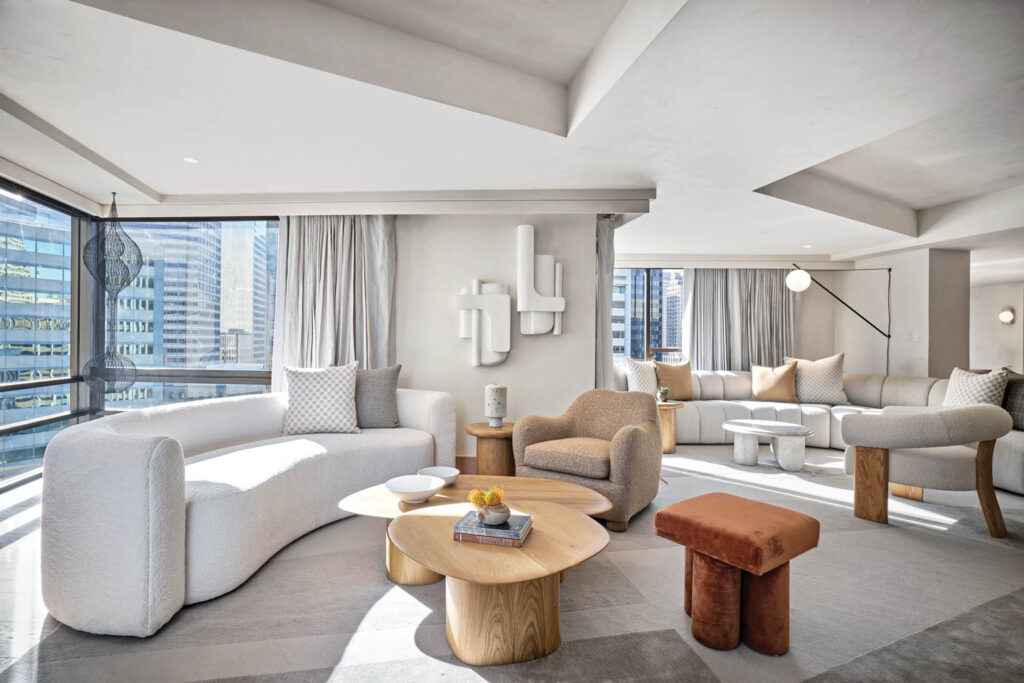 a common area with a white couch and earth tone furnishings