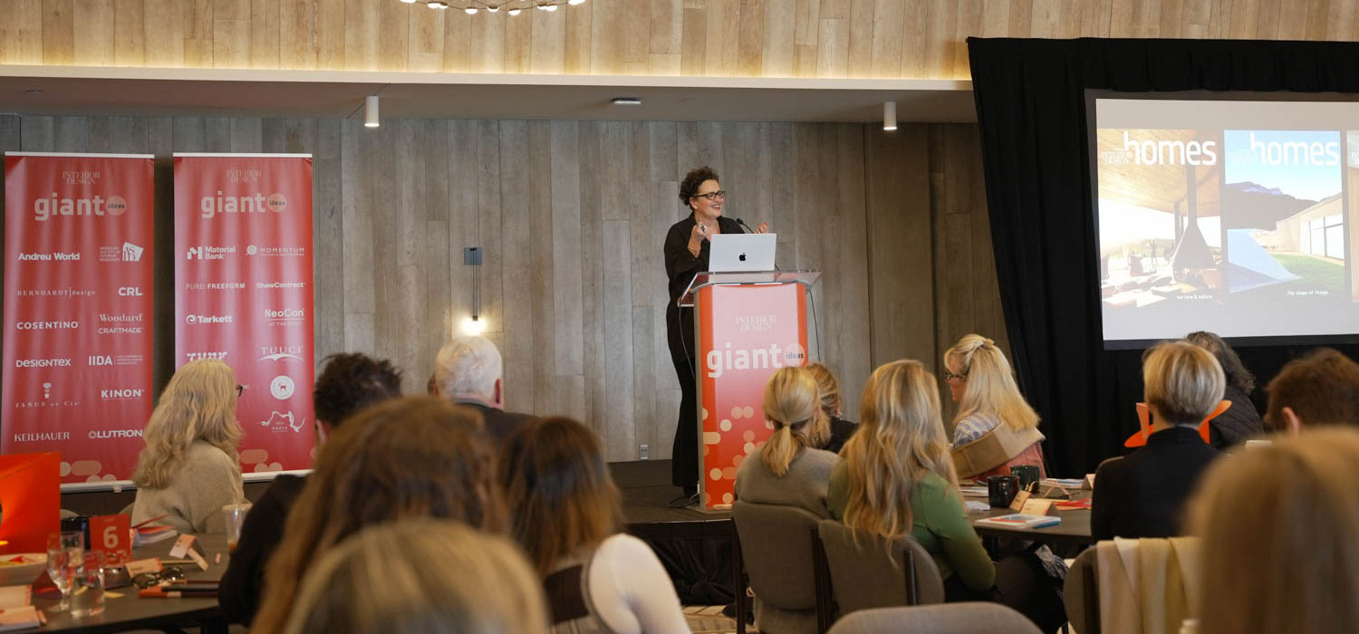Cindy Allen stands in front of a podium on stage at Giants 2023.