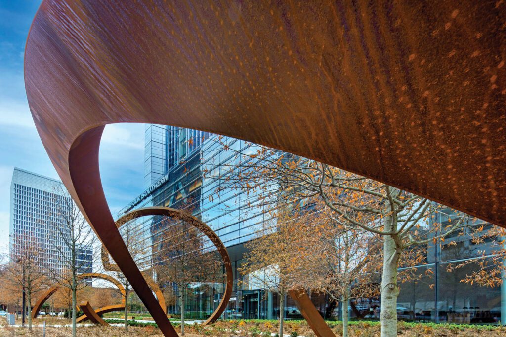 Can’t You See, a weathering-steel sculpture by Pennsylvania artist Dee Briggs, alludes to train tracks, movement, and tunnels.