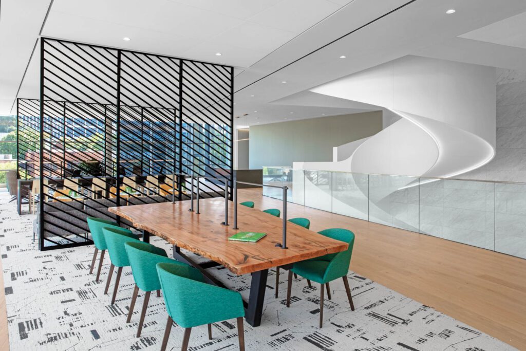 In a second-floor lounge, Lievore Altherr Molina armchairs flank a live-edge table made with sycamore from a tree in Bronson Forest, North Carolina, which Norfolk Southern owns.