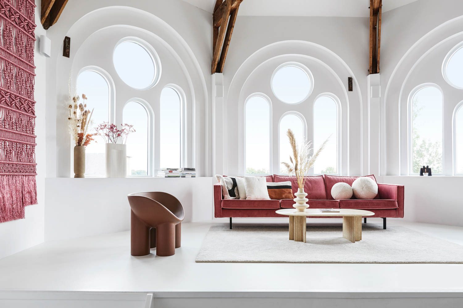 A sofa from Be Pure Home and a chair from Roly Poly furnish the living room of the former chapel.