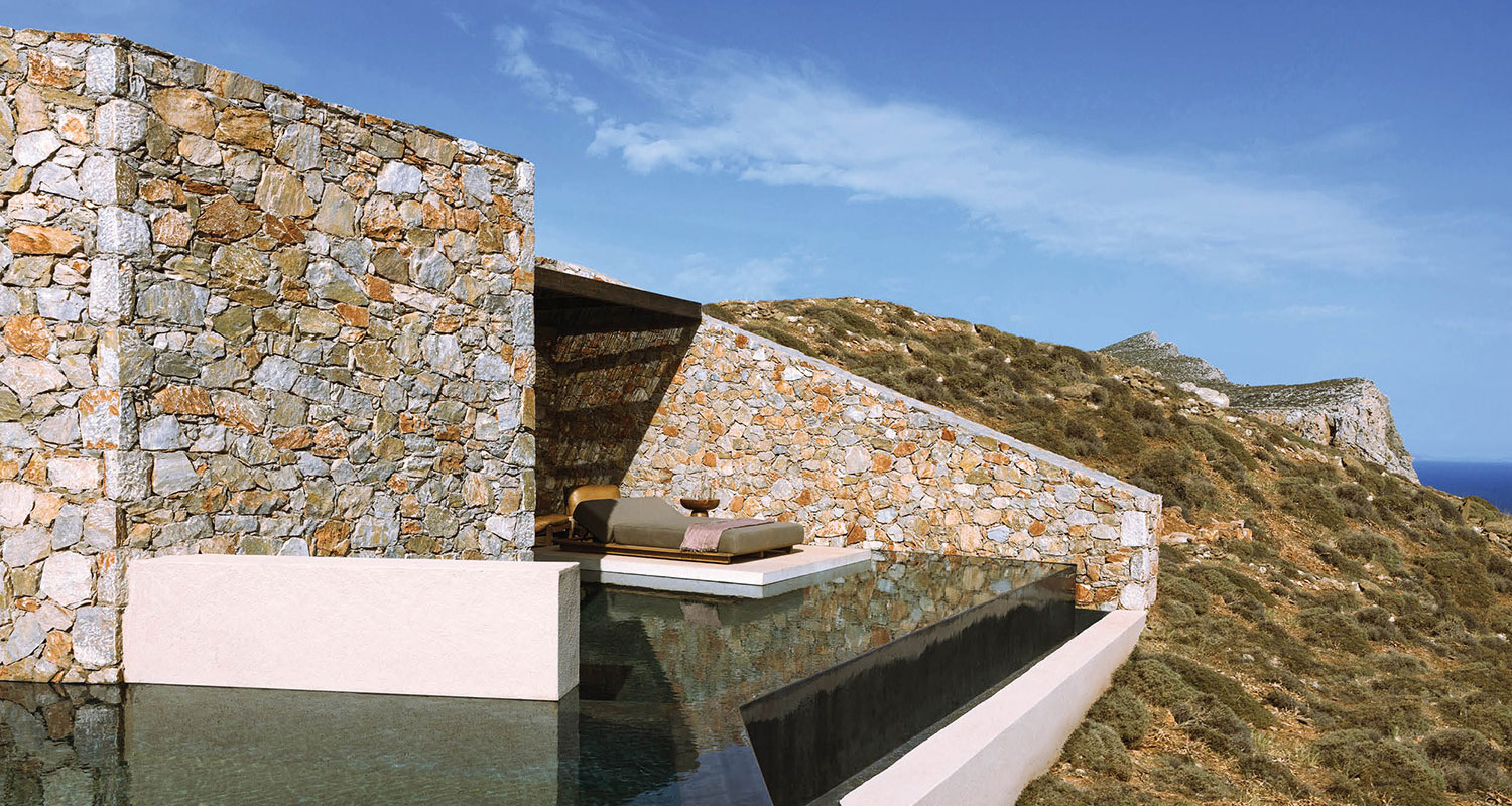 a lounge overlooking a hill with stone walls