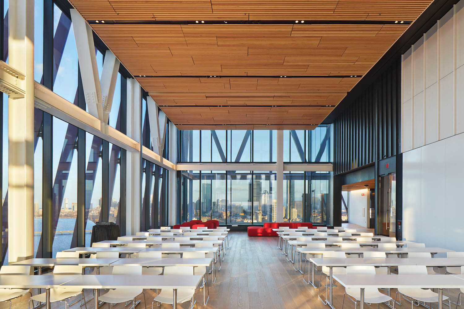 an academic building's event space with views of the Charles River