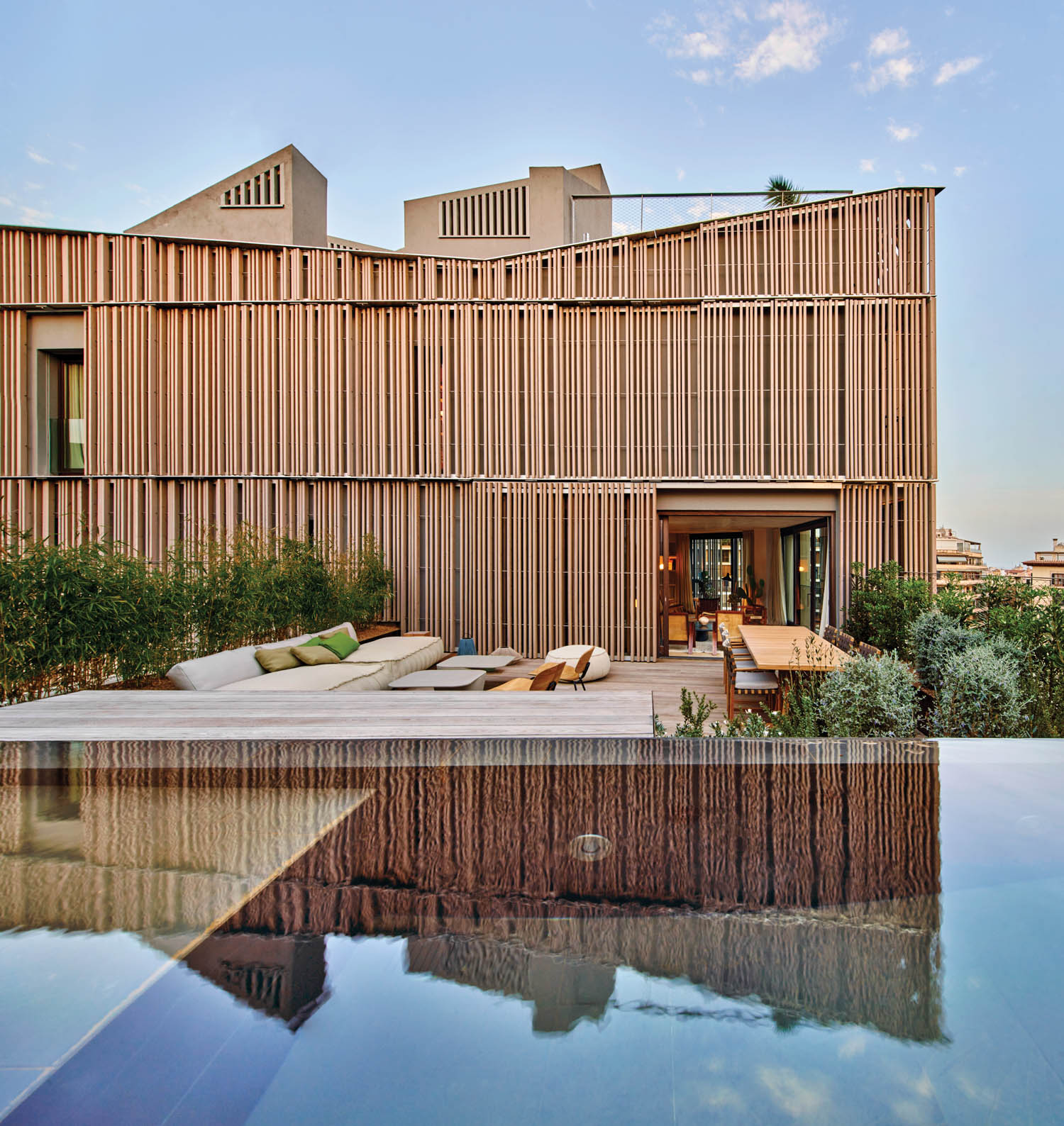 a penthouse living room opens up to an ash terrace and plunge pool