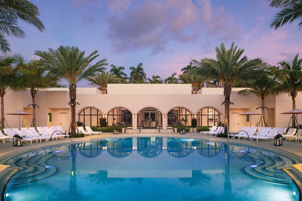 a pool surrounded by palm trees