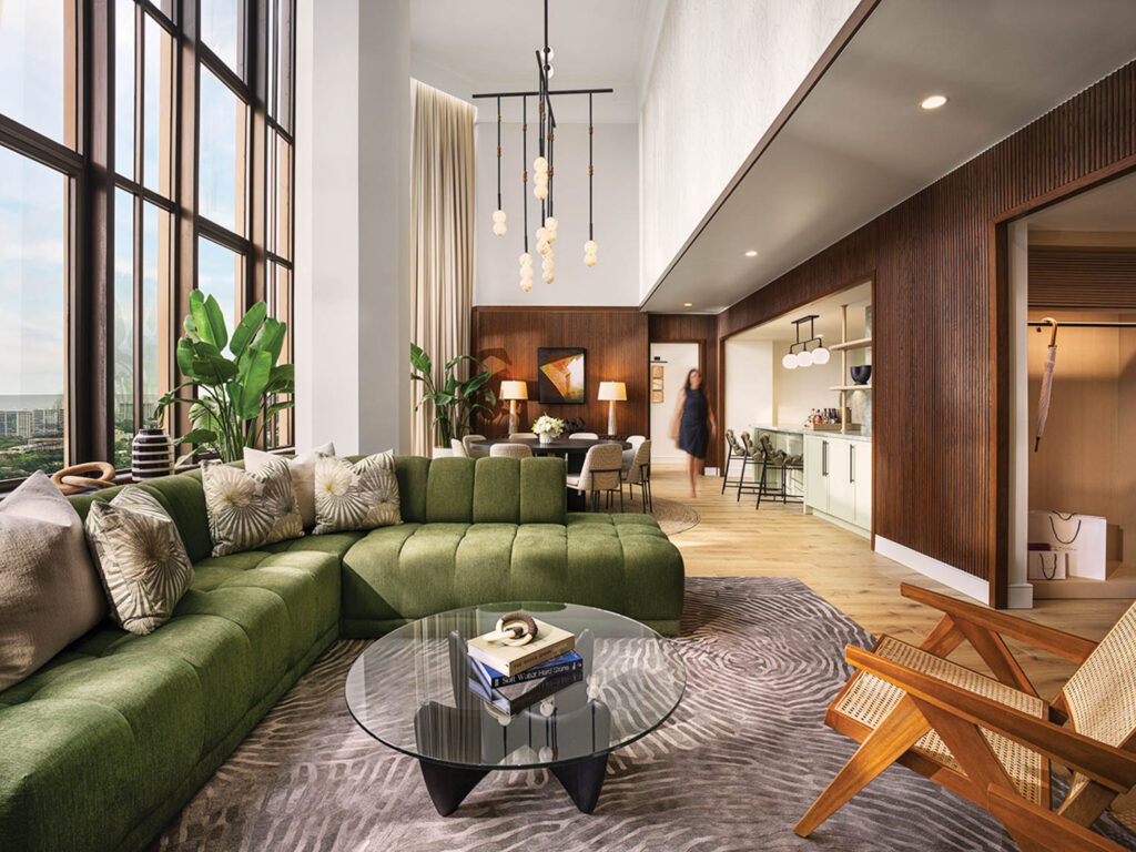 a lounge area with a green sofa