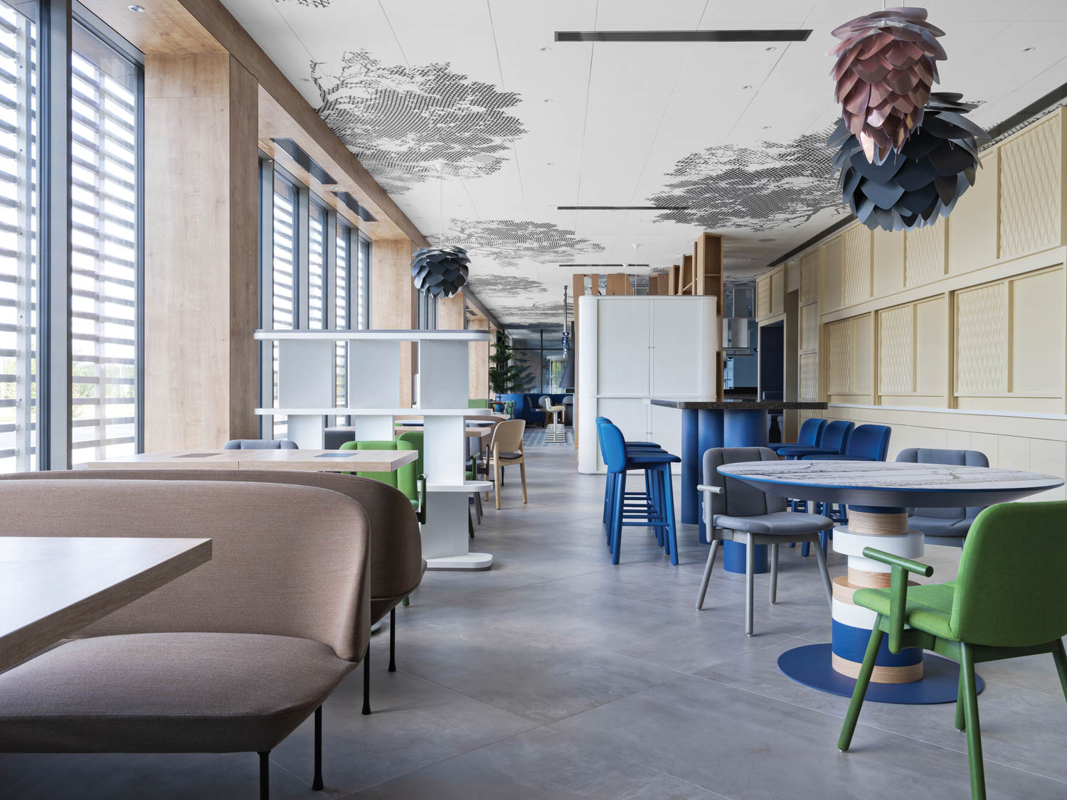 Aluvia pendant fixtures made of precision-cut aluminum leaves hang above tables in this hotel restaurant