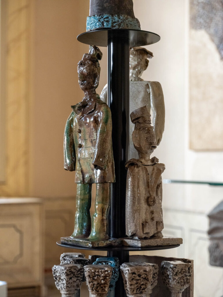 a sculptural lamp with a person carved into the base