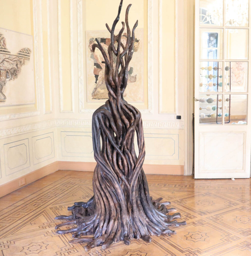 a woman figure that looks made of tree branches