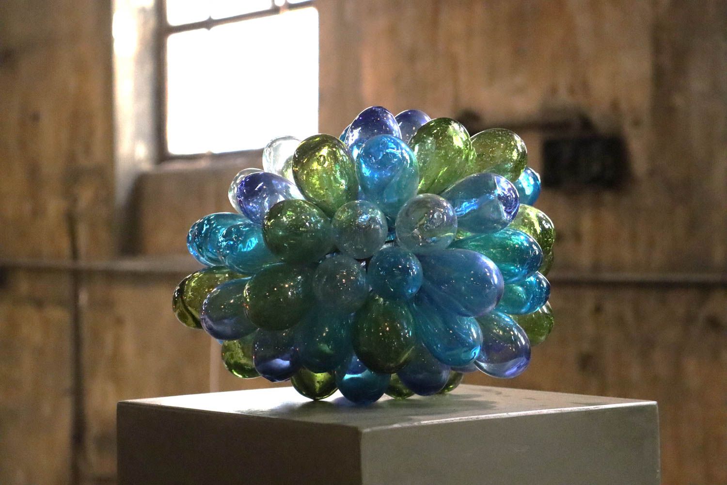 a bulbous glass object in blue and green