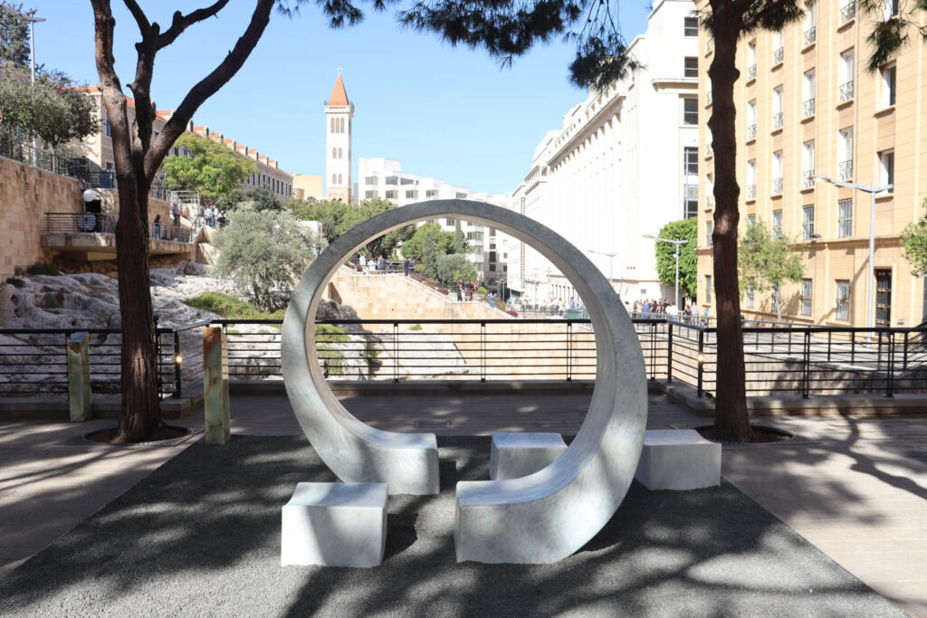 a curved sculptural shape on a patio with city views