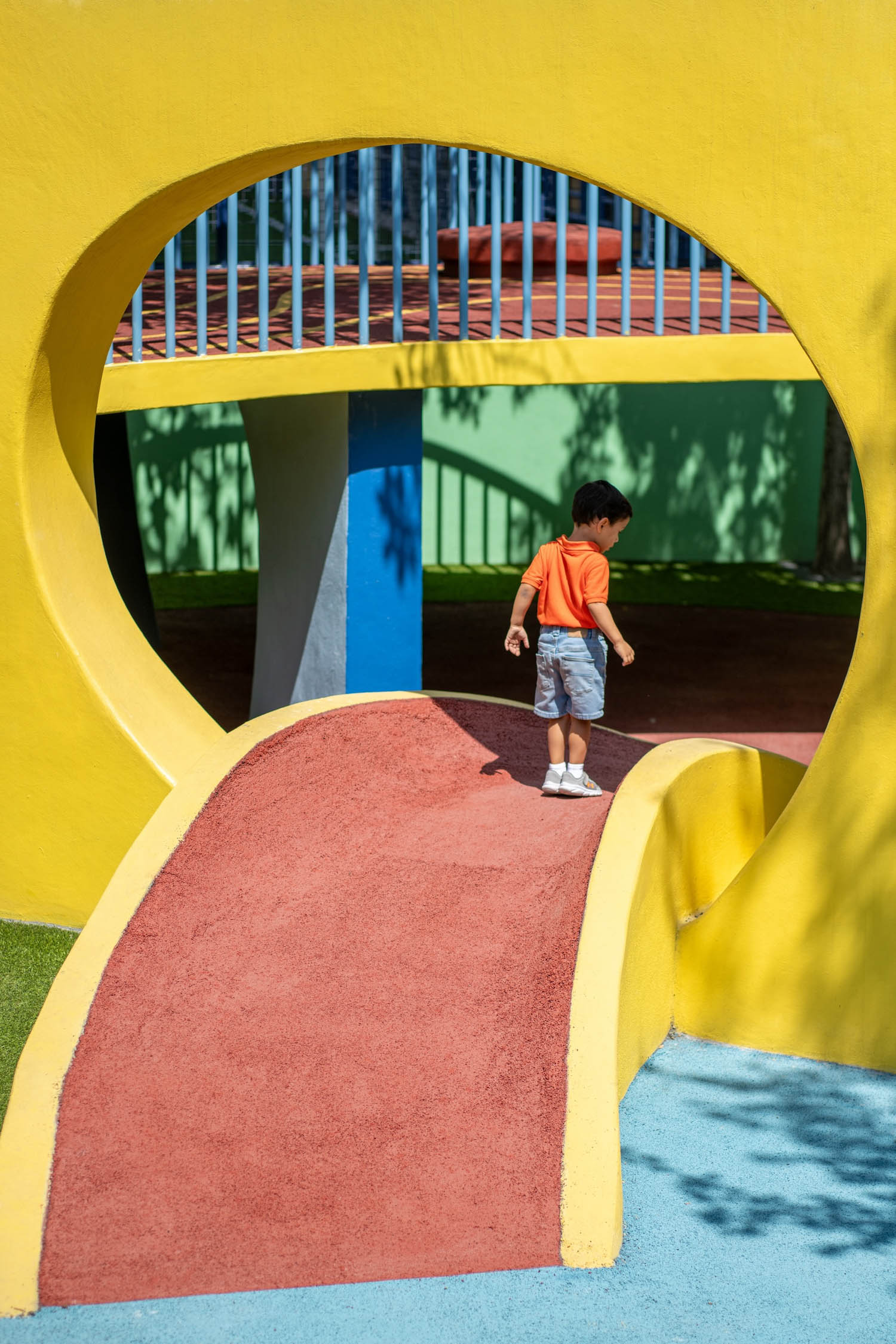 kid on a colorful yellow slide