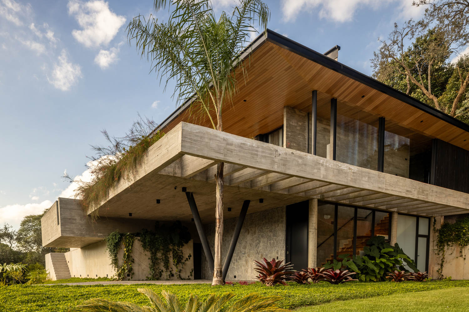 Exterior of home with steel columns and light steel-and-wood roof