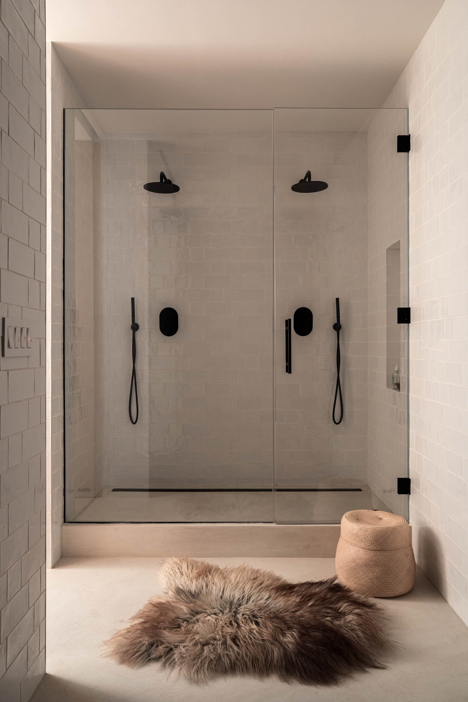 bathroom with clear shower doors and fuzzy rug