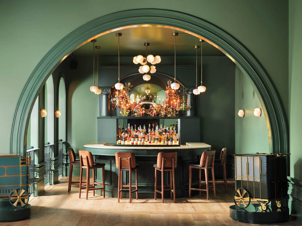 bar area with arched entryway and sage green walls