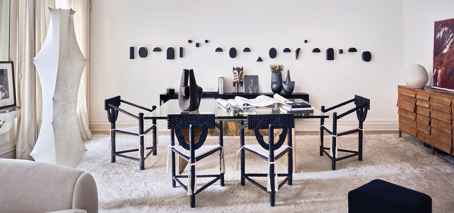 dining room with large glass table and black chairs