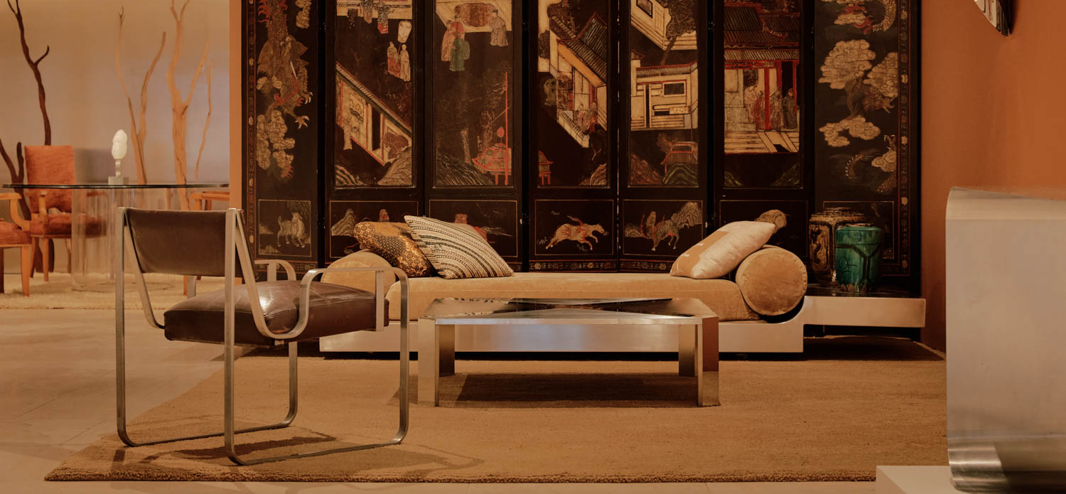 room with daybed and silver table in front of divider