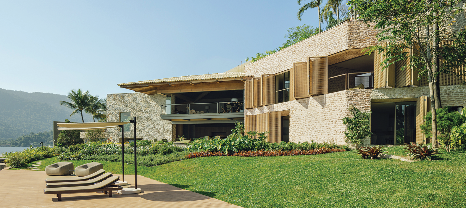 A house with a large lawn and a wooden deck